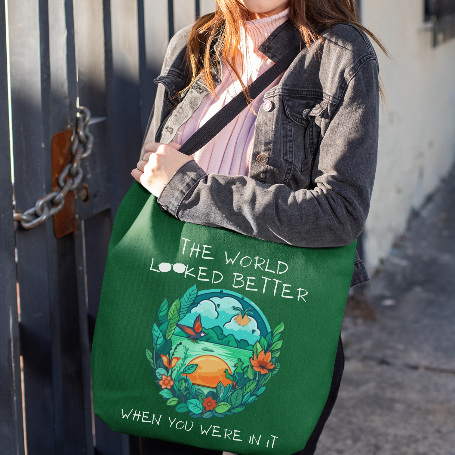 Green Grief Tote Bag with a nature graphic in blues and greens, and the message "The world looked better when you were in it."