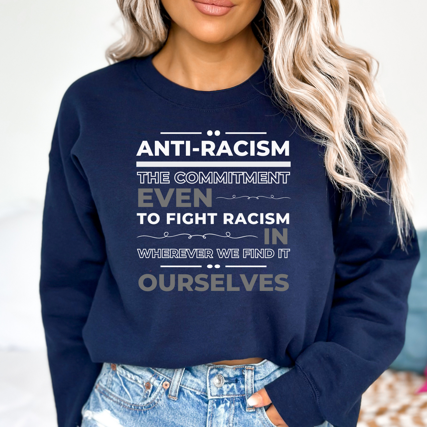 Navy women's sweatshirt with a strong anti-racism message. Use fashion to stand up for justice and equality. 