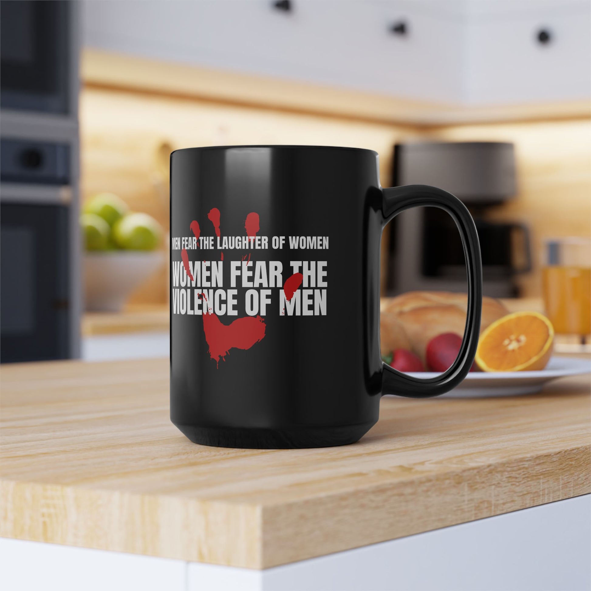 Black coffee mug 15 ounces, with a red handprint and the strongly anti-violence message: Men Fear the Laughter of Women. Women Fear the Violence of Men.  Ideal gift for survivors of domestic violence, support groups, therapists and counselors. 