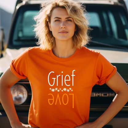 Orange Bella Canvas 3001 t-shirt with flowers and Grief over Love design. A simple elegant message stating that grief exist because of love.