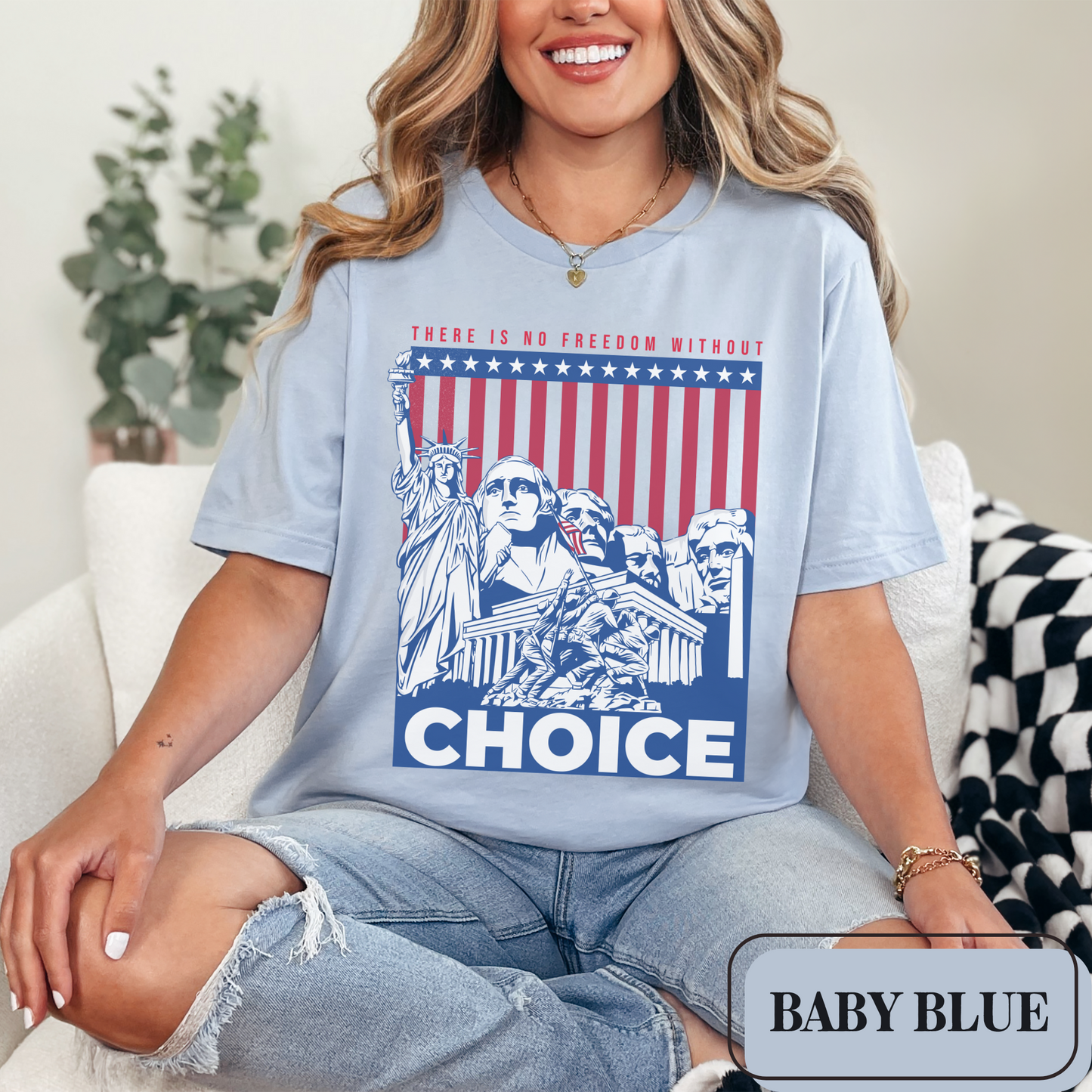 Baby Blue Bella Canvas 3001 T-shirt with a patriotic design featuring the Statue of Liberty, Mount Rushmore, and an American Flag with soldiers. Women's fight for freedom is still ongoing - join us in advocating for a woman's right to choose and bodily autonomy. Support Roe V Wade.