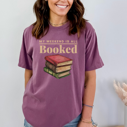 Celebrate your love for reading with this comfort colors t-shirt that says "My Weekend is All Booked." Perfect for bookworms who enjoy spending their weekends lost in a good book. (color: berry)