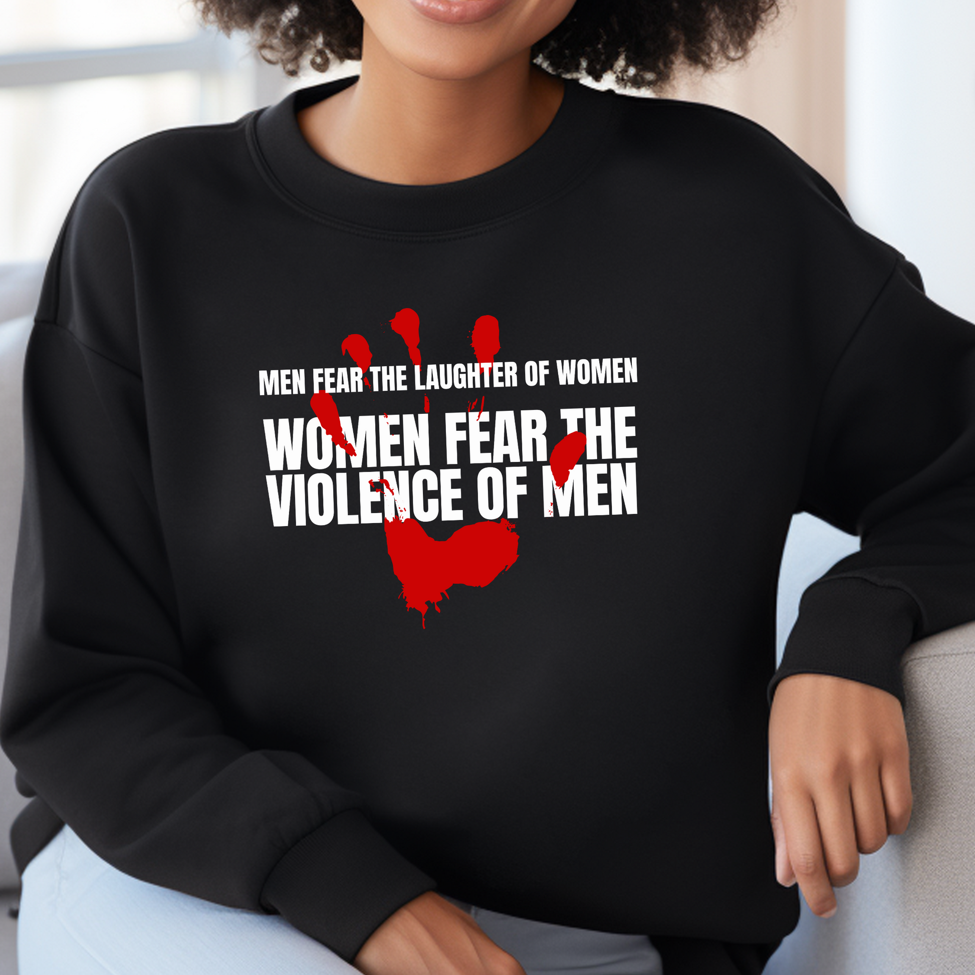 Black Gildan 18000 Sweatshirt with a red handprint graphic and the saying: Men Fear The Laughter of Women. Women Fear the Violence of Men.