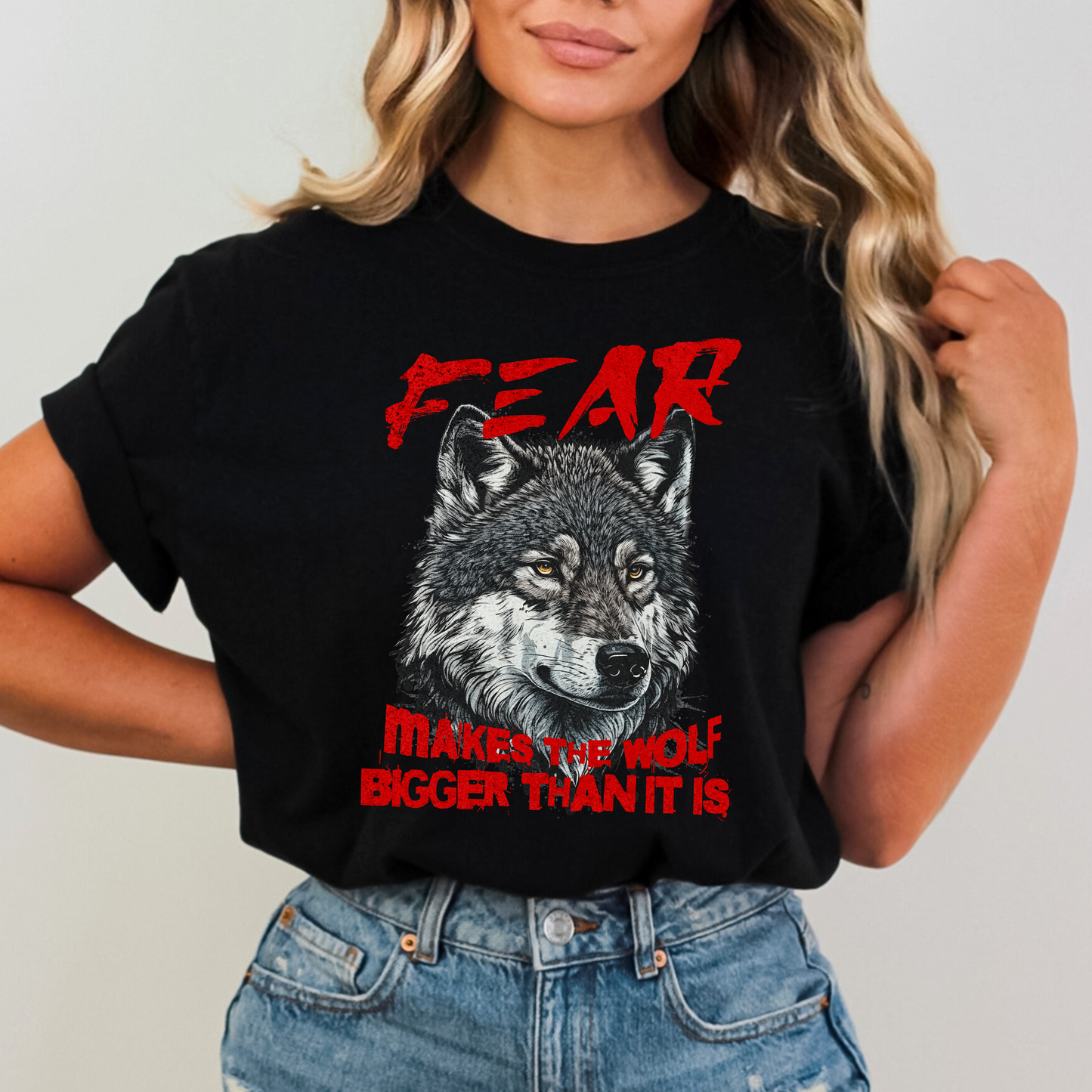 Black Comfort Colors t-shirt with a wolf graphic and the phrase: Fear Makes The Wolf Bigger Than It Is. Ideal gift for anyone struggling with fearful challenges to motivate and inspire. 