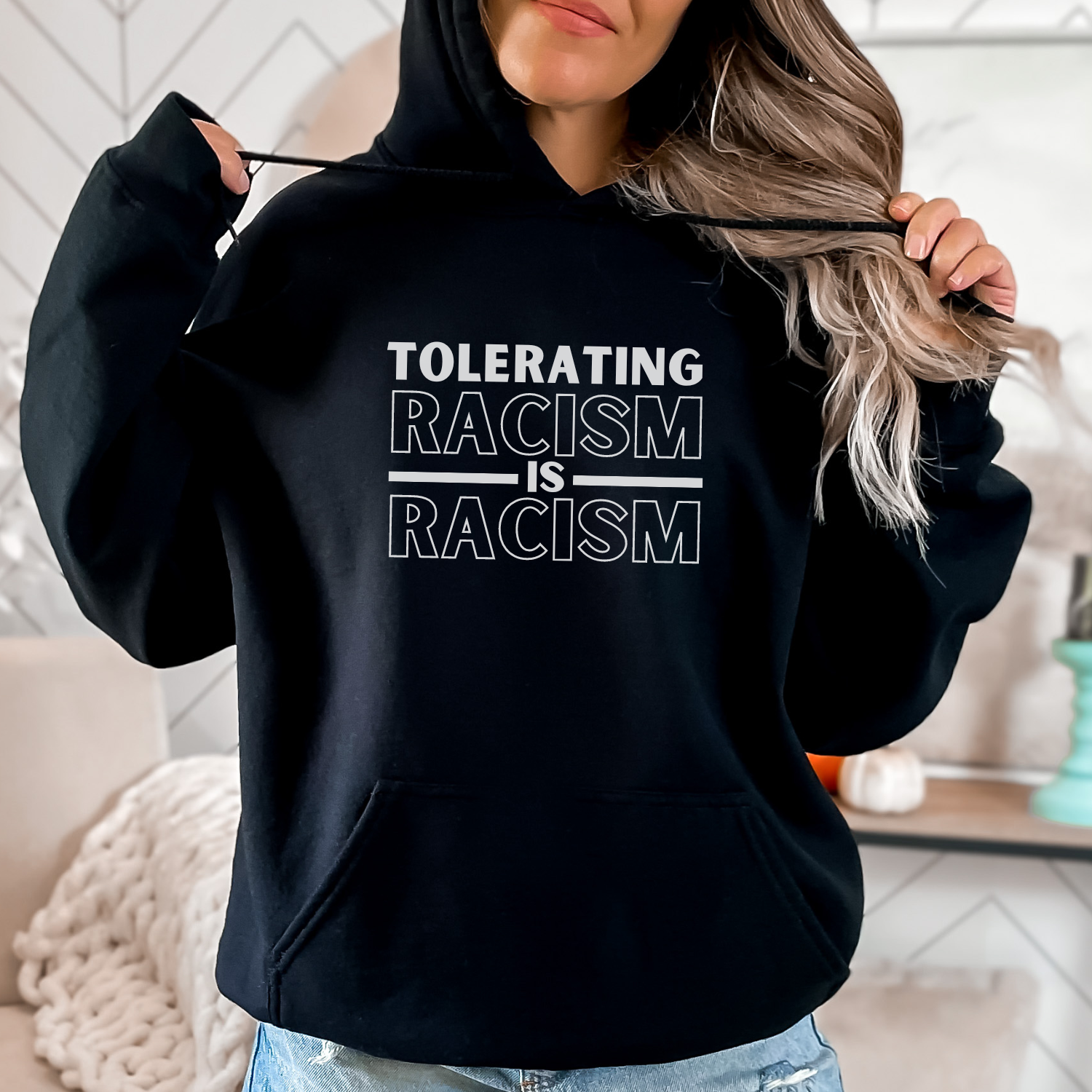 Show your commitment to social justice and awareness with this hoodie that states, 'Tolerating racism is racism.' Gildan 18500 hoodie sweatshirt in color black.