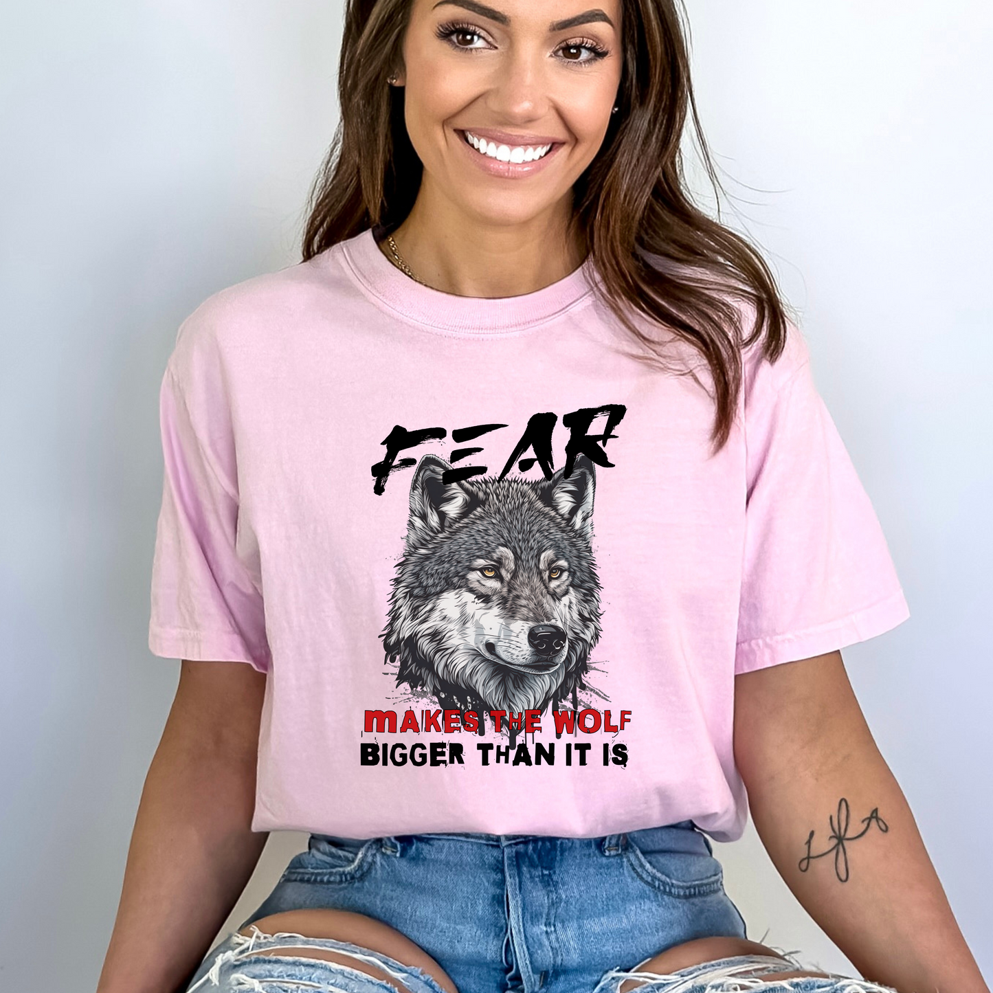 Blossom Comfort Colors t-shirt with a wolf graphic and the phrase: Fear Makes The Wolf Bigger Than It Is. Ideal gift for anyone struggling with fearful challenges to motivate and inspire. 