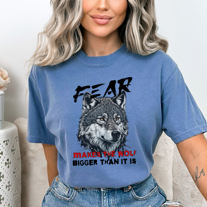 Blue Jean Comfort Colors t-shirt with a wolf graphic and the phrase: Fear Makes The Wolf Bigger Than It Is. Ideal gift for anyone struggling with fearful challenges to motivate and inspire. 