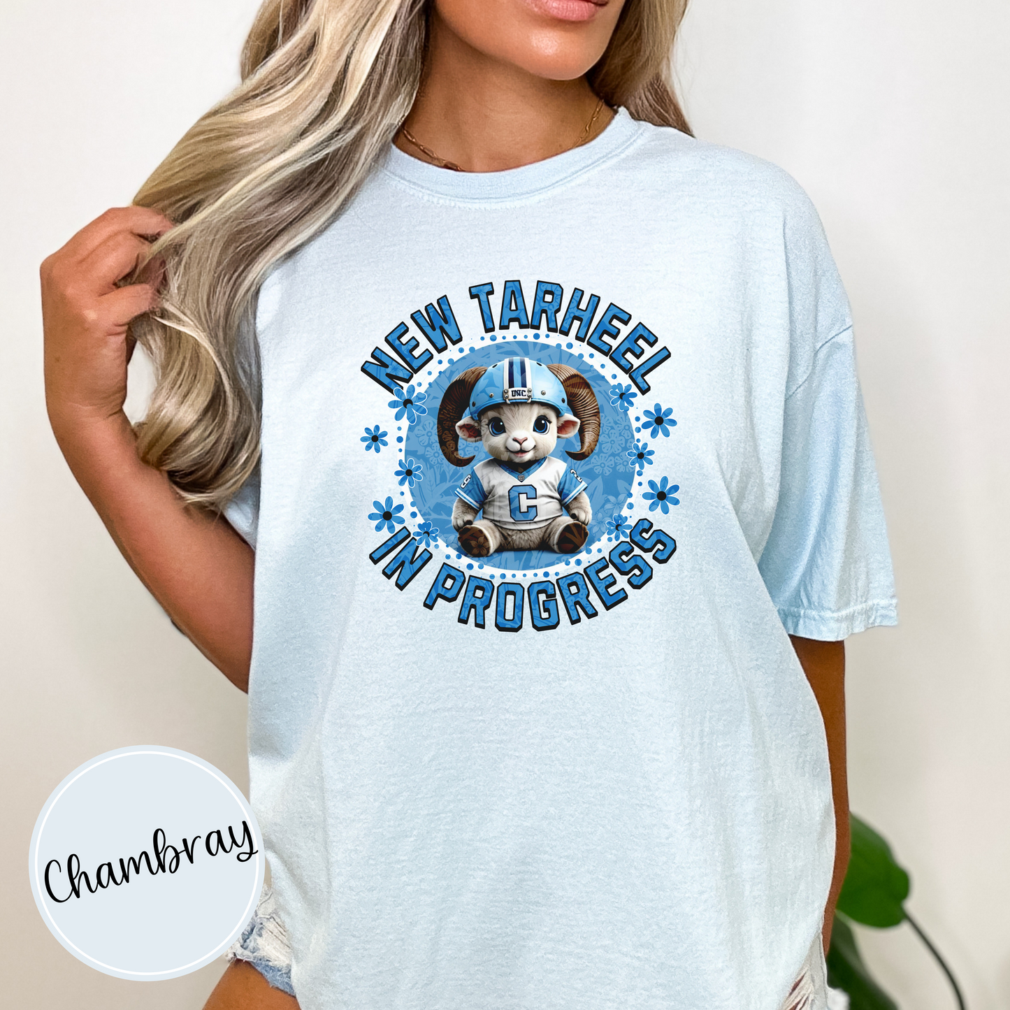 Chambray Comfort Colors t-shirt for tarheel fans and mother-to-be. These oversized tees are perfect for early maternity life, and show your love for Carolina sports. It features an adorable baby ram in a football helmet and jersey with the words New Tarheel In Progress.