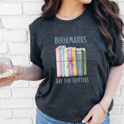 Dark heather gray t-shirt. Every true book lover knows how hard it is to mark the pages and set their book aside. Share your love of reading with others when you wear this tee, sharing a bibliophiles' inside joke.