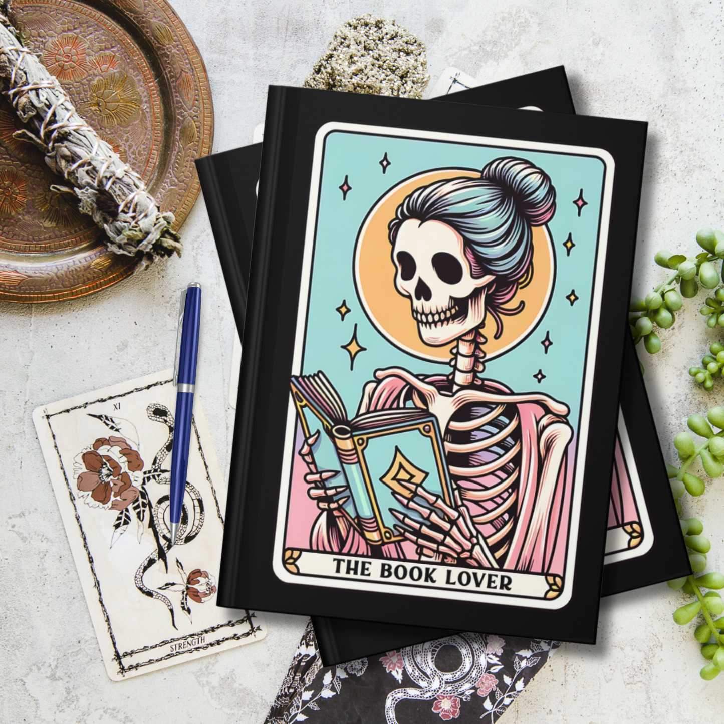 150 page Hardcover Journal for reading lovers. Includes a Tarot Card themed graphic for "The Book Lover" with a skeleton reading - front and back cover print. Lined, blank, perforated pages - makes a cute gift for bookish girlfriends, teachers, English majors, and avid readers.