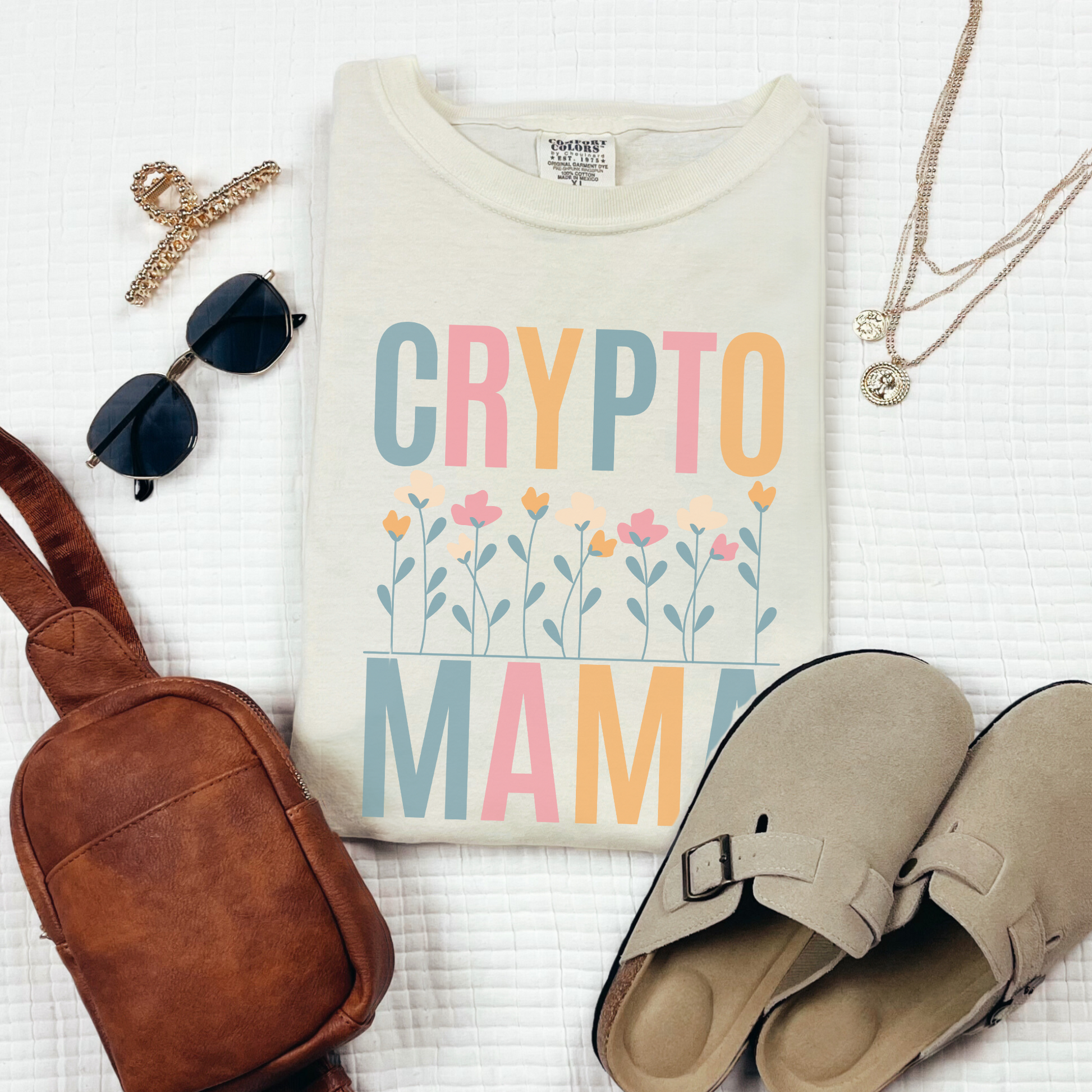 Ivory Comfort Colors 1717 T-shirt that says "Crypto Mama" with a color set of flowers. Perfect gift for your wife, girlfriend, sister, or friend that works in finance and supports crypto currency. The future of banking is blockchain.