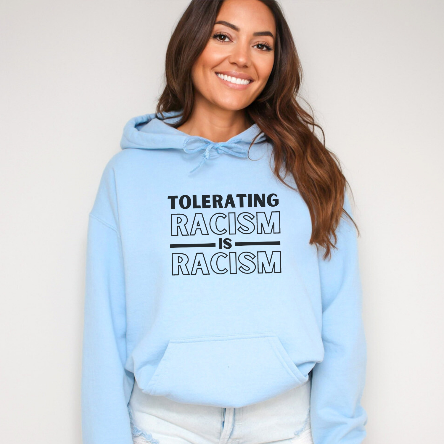 Encourage a culture of awareness and action against discrimination with a hoodie that states unequivocally, 'Tolerating racism is racism.' Gildan 18500 hooded sweatshirt, color light blue.
