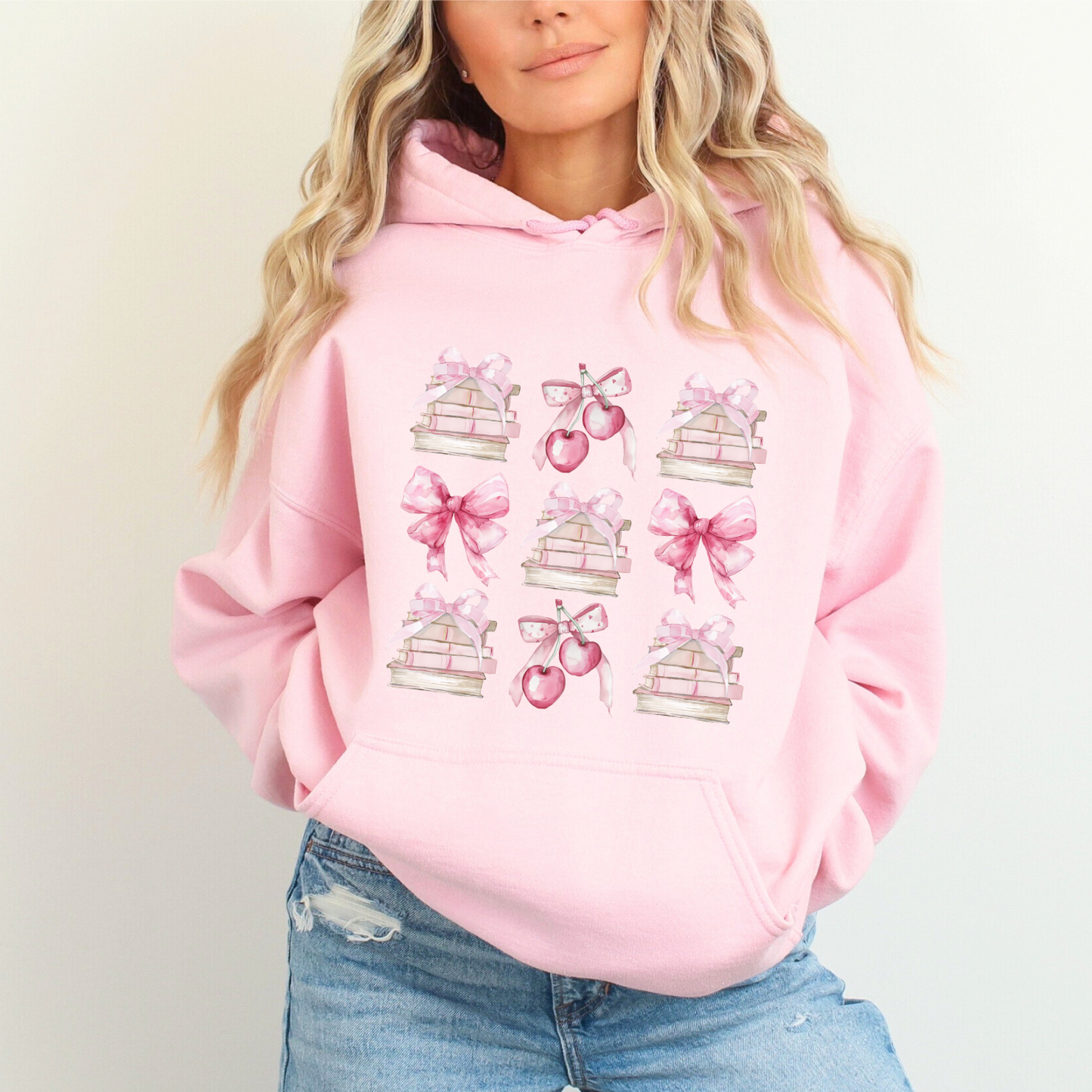 Light Pink Gildan 18500 Hoodie sweatshirt with a coquette pink design. Filled with books, bows and cherries, it's the perfect gift for the avid reader, book lover, librarian, or English/Reading teacher, student, graduate in your life. Makes a great reading outfit idea.