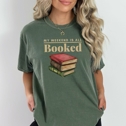  Embrace your love for literature with this "My Weekend is All Booked" t-shirt in the color Moss. It's the perfect companion for a weekend of uninterrupted reading.