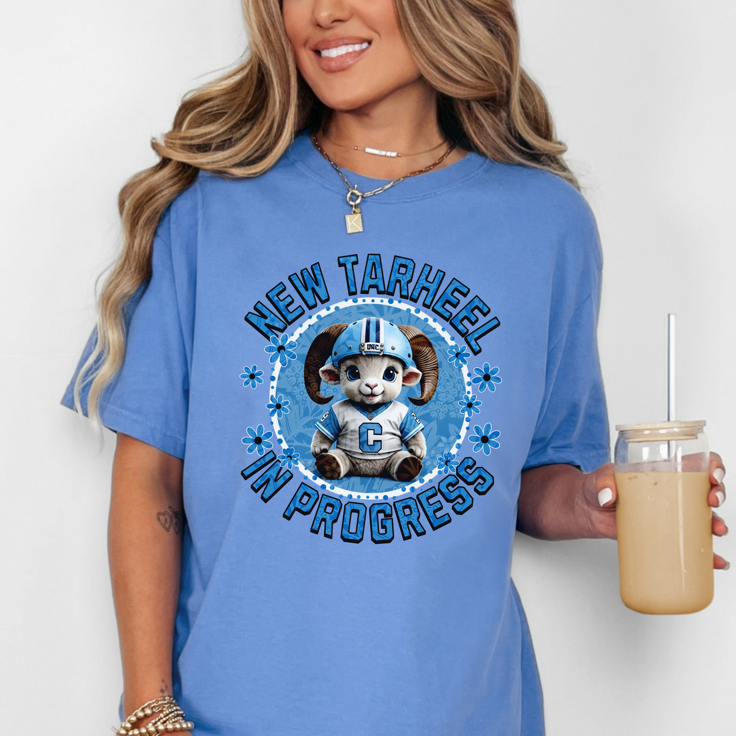 Mystic Blue Comfort Colors t-shirt for tarheel fans and mother-to-be. These oversized tees are perfect for early maternity life, and show your love for Carolina sports. It features an adorable baby ram in a football helmet and jersey with the words New Tarheel In Progress.