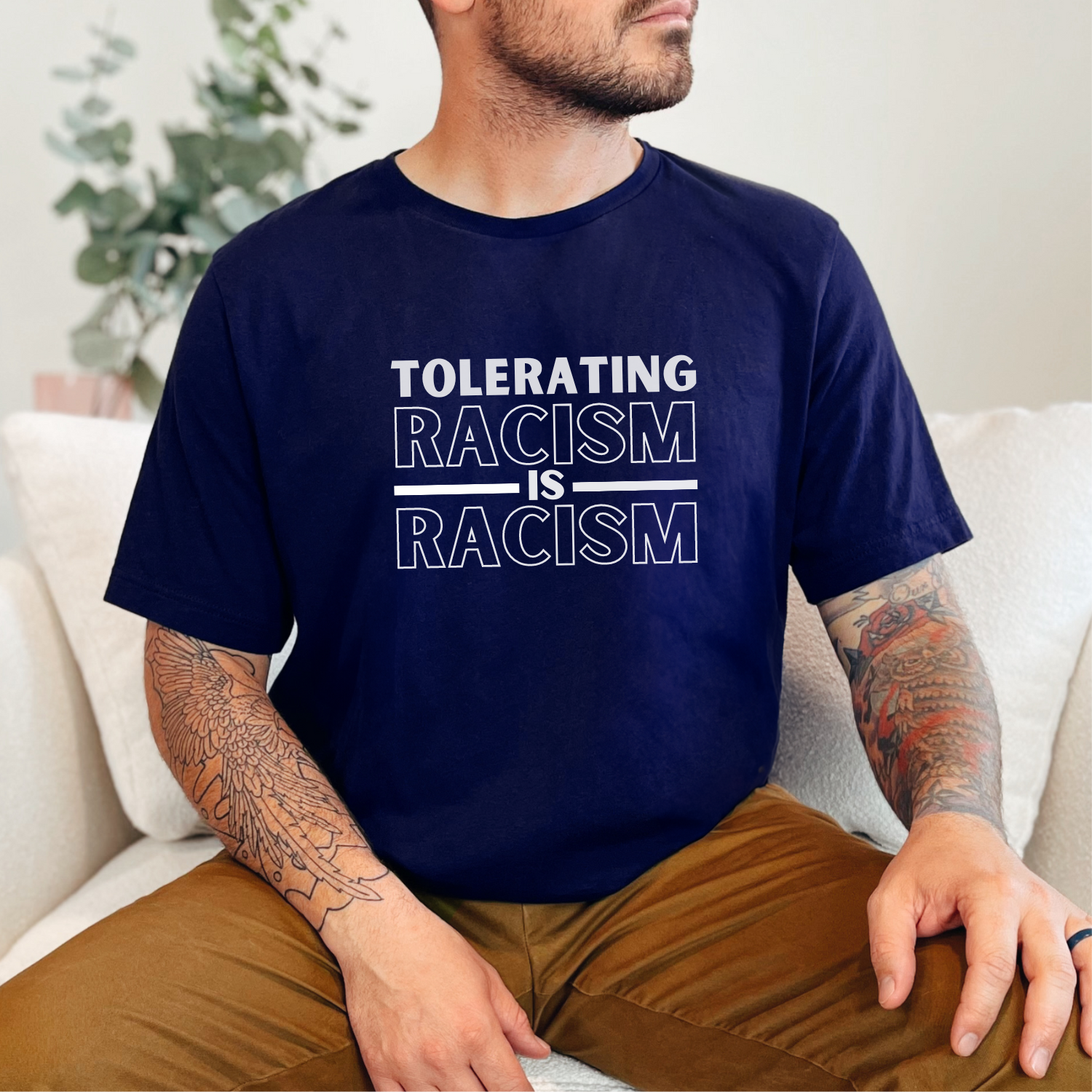 Show your commitment to social justice and awareness with this tee that states, 'Tolerating racism is racism.' - Bella Canvas 3001 in navy.