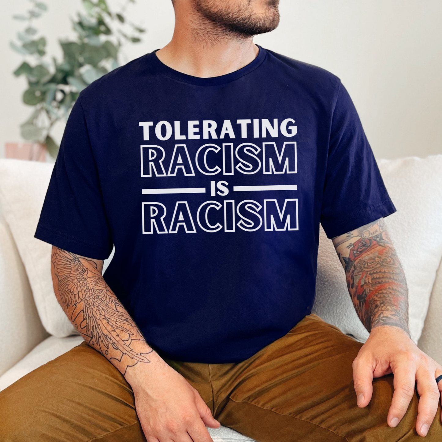 Navy Bella Canvas 3001 T-shirt that says "Tolerating Racism Is Racism" in a bold black font. Perfect gift for the activist in your life supporting Black Lives Matter, equality, and social justice for all. Wear it to a protest, rally or in every day life as a conversation starter.