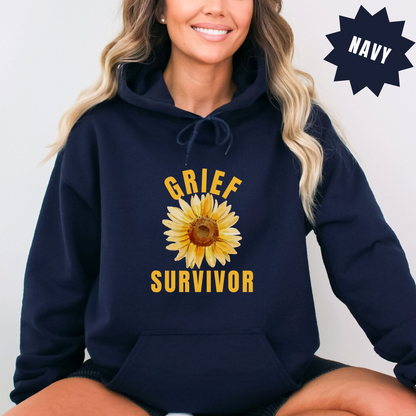 Sunflower-themed hoodie sweatshirt that serves as a statement of survival, hope and the enduring strength of the human spirit during loss. Gildan 18500 in Navy. "Grief survivor"