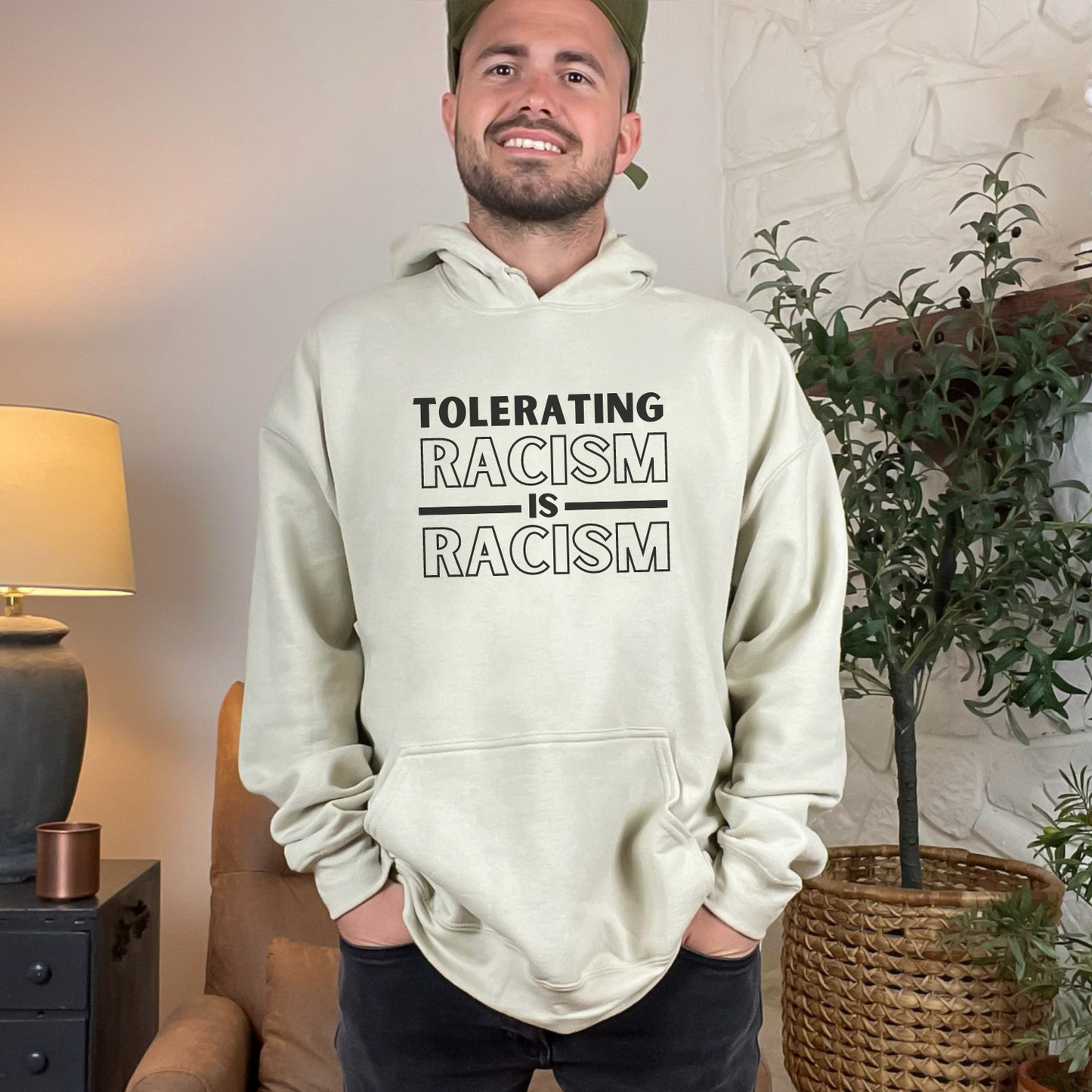 Gildan 18500 hoodie sweatshirt that has a clear and powerful message against racism. "Tolerating Racism Is Racism" - color sand with black design.