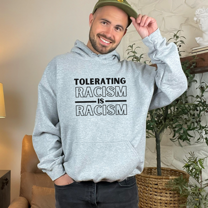 Promote anti-racism and inclusivity with this hoodie that reinforces the critical message: 'Tolerating racism is racism.' Gildan 18500 hooded sweatshirt in color sport grey. Unisex design.