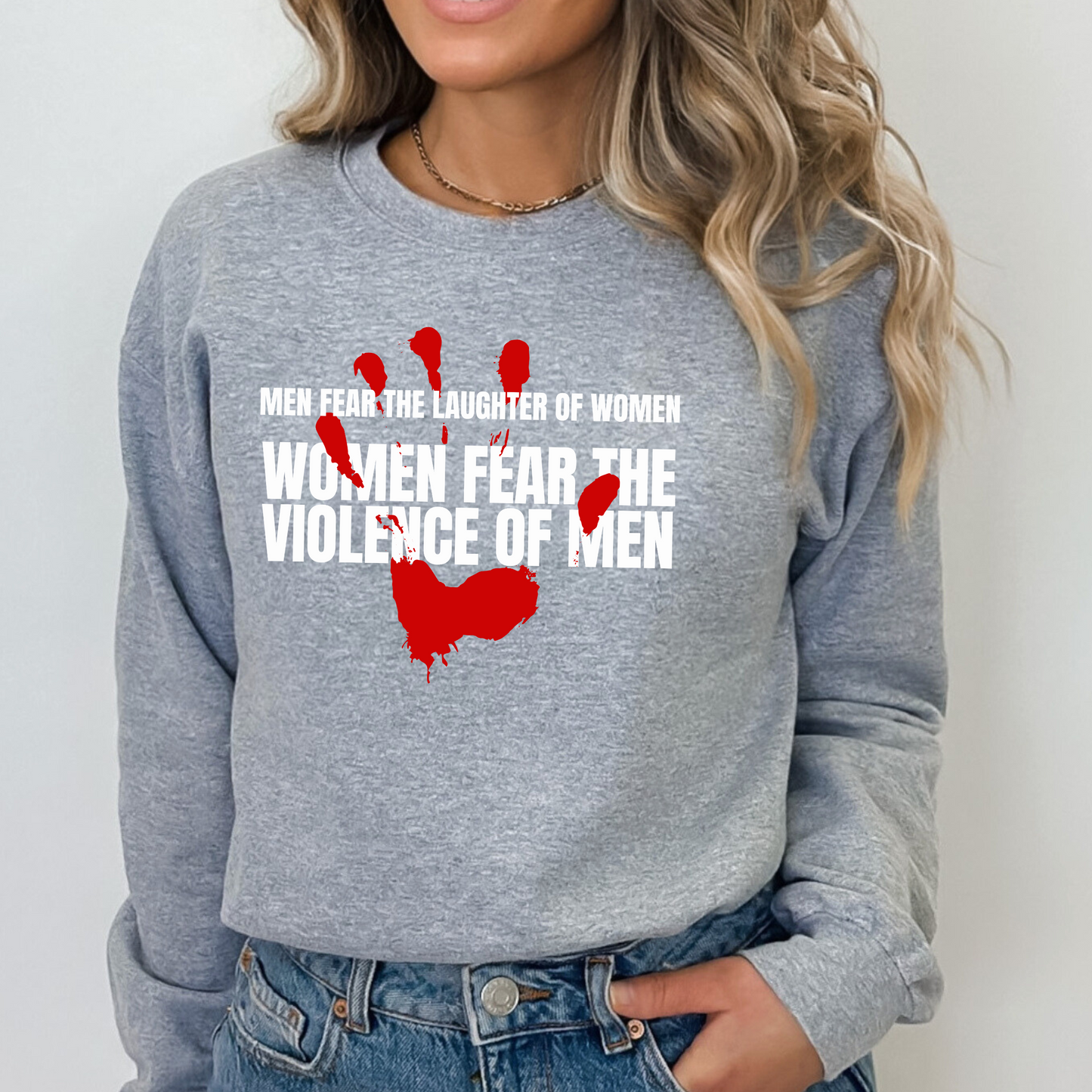 Sport Gray Gildan 18000 Sweatshirt with a red handprint graphic and the saying: Men Fear The Laughter of Women. Women Fear the Violence of Men.