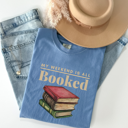  Celebrate your passion for reading with this "My Weekend is All Booked" t-shirt in color Washed Denim. A comfortable and stylish way to share your love for books.