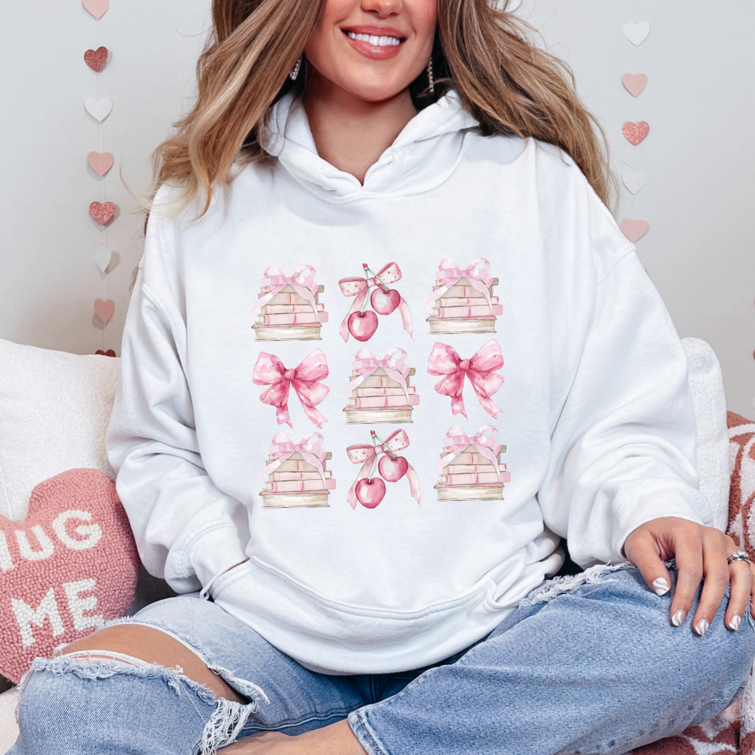 White Gildan 18500 Hoodie sweatshirt with a coquette pink design. Filled with books, bows and cherries, it's the perfect gift for the avid reader, book lover, librarian, or English/Reading teacher, student, graduate in your life. Makes a great reading outfit idea.