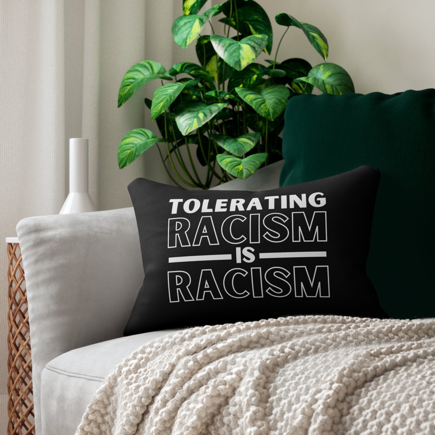 Encourage a culture of inclusivity and awareness with this pillow that makes it clear: "Tolerating racism is racism." Black pillow, white design, size: 20" x 14"