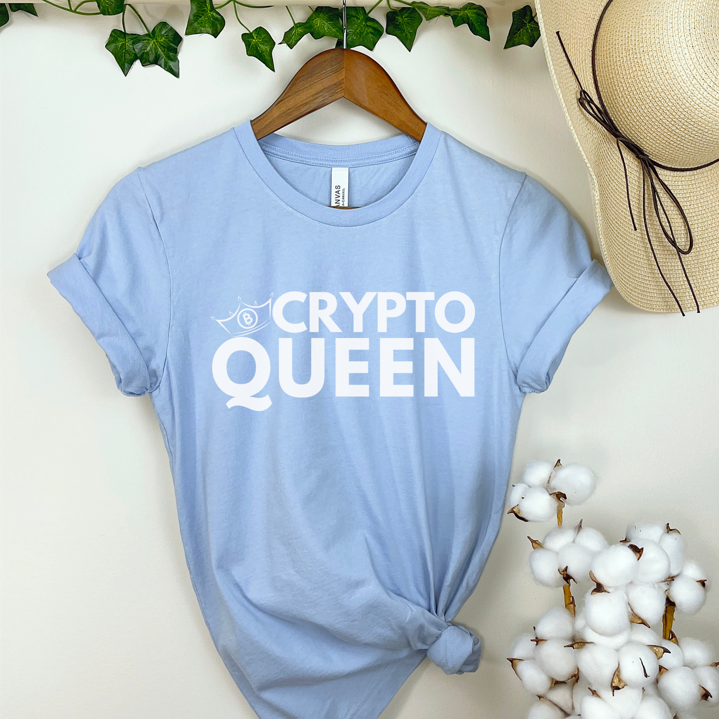 Baby Blue Bella Canvas 3001 T-shirt that says "Crypto Queen" with a crown and bitcoin symbol. It's the perfect gift for women in finance, supports of blockchain technology, and crypto currency.