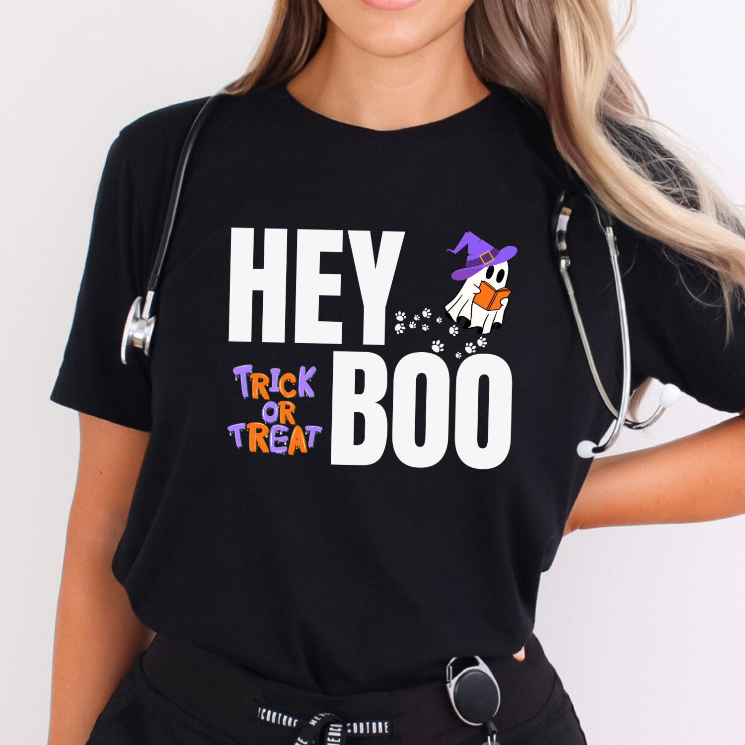 Black Hey Boo Halloween t-shirt with an adorable ghost reading with a witches hat on, and paw prints leading up to it. Trick or Treat.