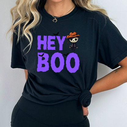 Black Comfort Colors Halloween t-shirt from our Hey Boo Collection, featuring a cute pumpkin-head skeleton and bats graphic.