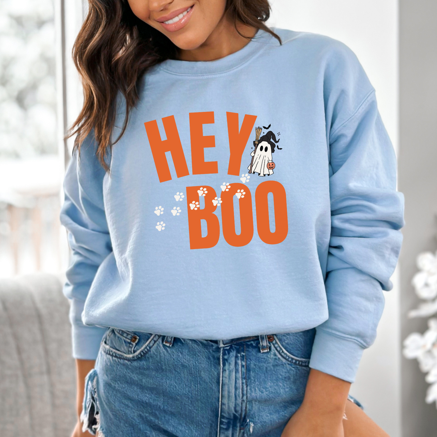 Light blue Gildan 18000 Halloween sweatshirt for dog-lovers, featuring an adorable ghost and paw prints from the Hey Boo Collection