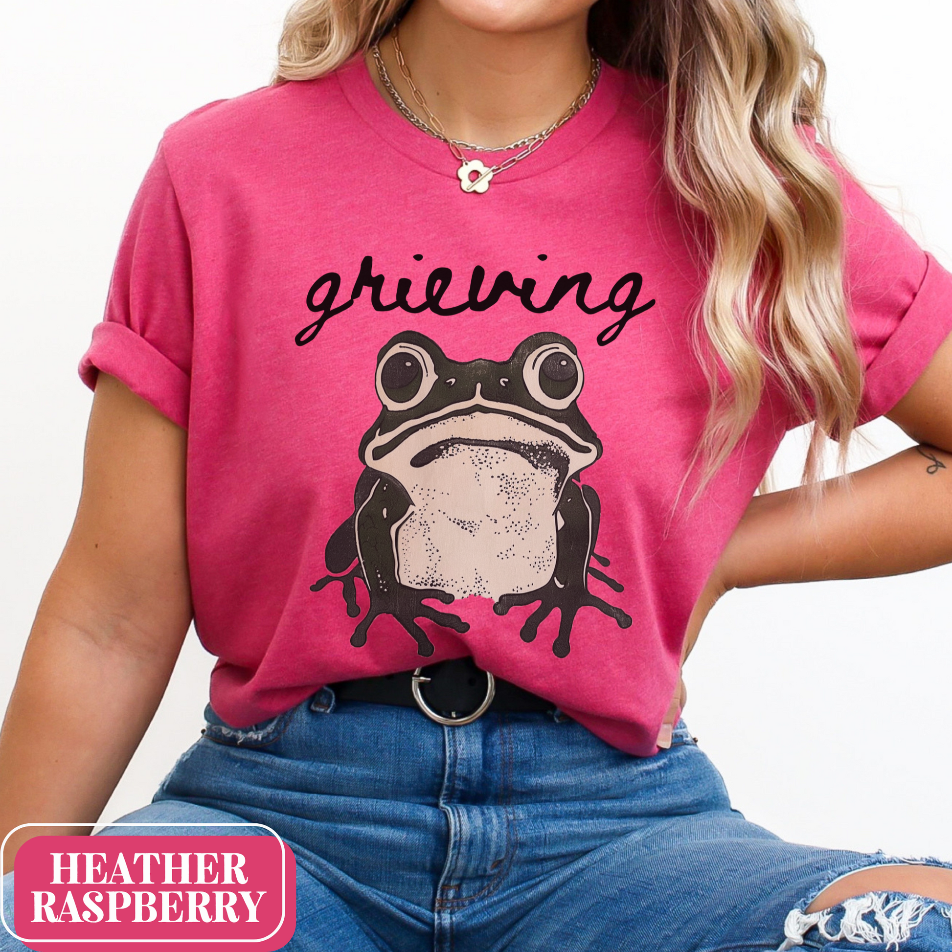 Heather Raspberry Bella Canvas 3001 T-shirt with a large frog graphic that says "Grieving". A way for people struggling with loss to convey their sorrow - makes a perfect gift for a friend or loved one struggling with grief.