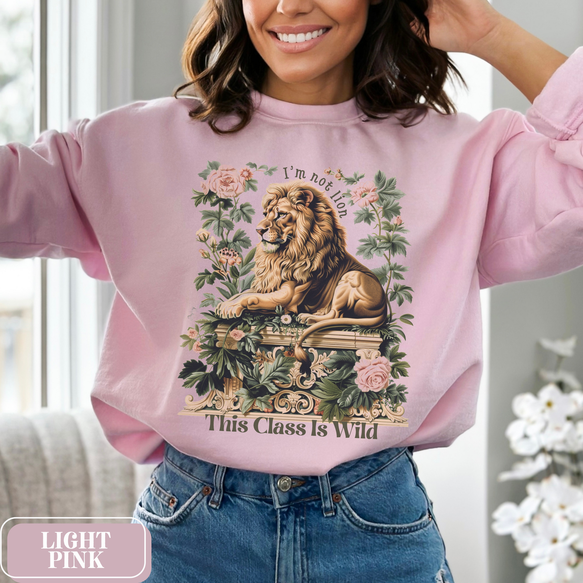 Light Pink Gildan 18000 Sweatshirt with a large Lion graphic with beautiful flowers that says "I'm Not Lion, This Class Is Wild" - perfect gift for teachers, educators, and education majors.