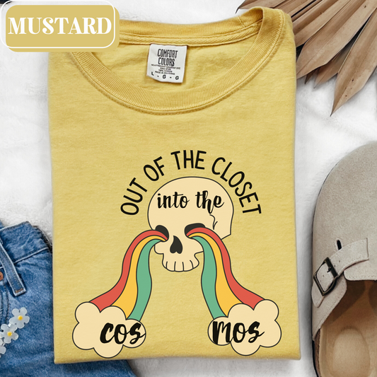 Mustard Comfort Colors 1717 T-shirt that says "Out Of The Closet, Into the Cosmos" with a rainbow, clouds and a skull graphic. Perfect for gay pride month or festival gift - love is love.