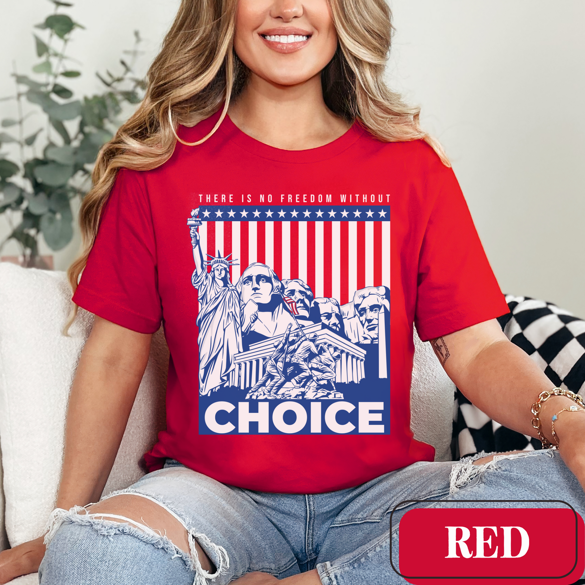 Red Bella Canvas 3001 T-shirt with a patriotic design featuring the Statue of Liberty, Mount Rushmore, and an American Flag with soldiers. Women's fight for freedom is still ongoing - join us in advocating for a woman's right to choose and bodily autonomy. Support Roe V Wade.