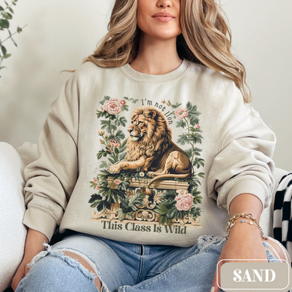 Sand Gildan 18000 Sweatshirt with a large Lion graphic with beautiful flowers that says "I'm Not Lion, This Class Is Wild" - perfect gift for teachers, educators, and education majors.